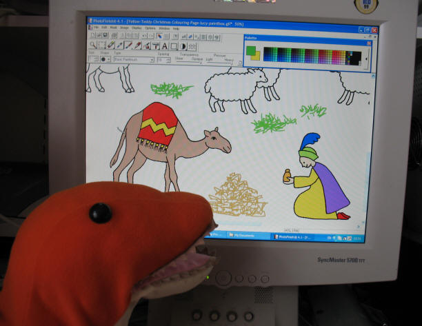 Dino colouring the Christmas Story page on screen