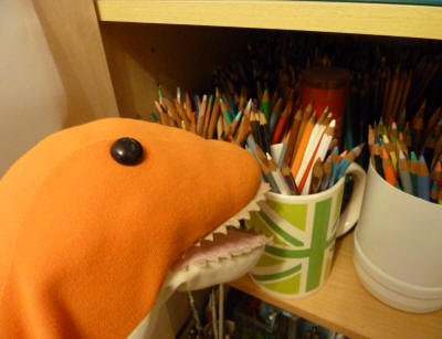 Dino choosing pencils from the art cupboard