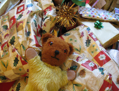 Yellow Teddy with pile of presents