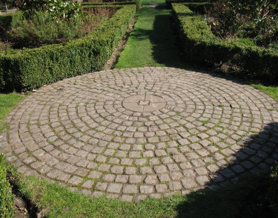 Circle of granite stones in Priory Park hedge garden