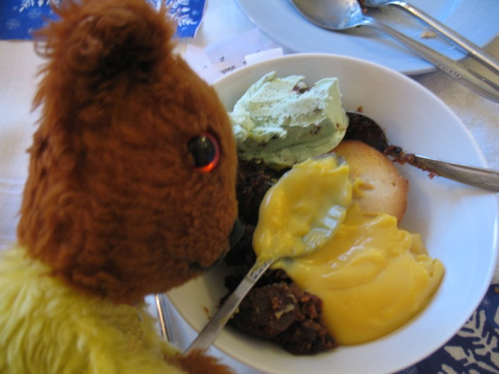 Yellow Teddy with Christmas pudding and custard