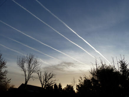 Dawn sky with airplane vapour trails