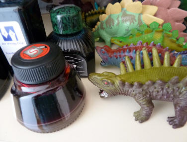 Ink bottles and toy dinosaurs