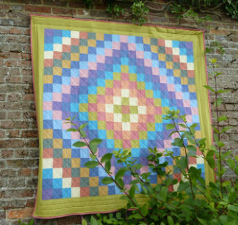 Quilt hanging on garden wall