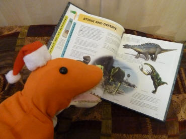 Dino reading his dinosaur book