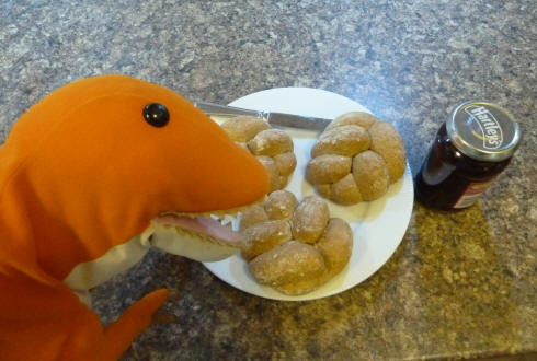 Dino having his Dinosaur Footprint rolls with raspberry jam