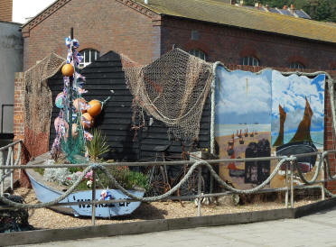 Boat display with flowers by roadside