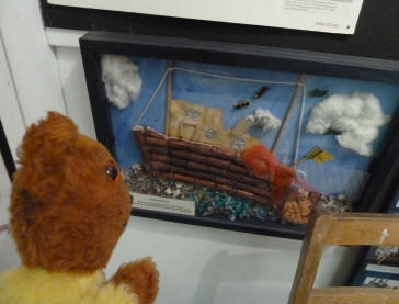 Yellow Teddy admiring applique picture of boat