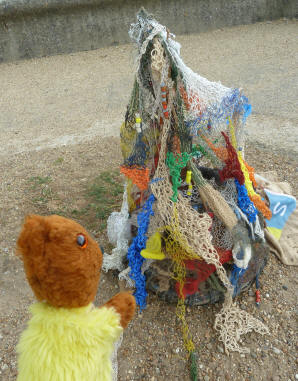 Yellow Teddy with net ornament on seafront