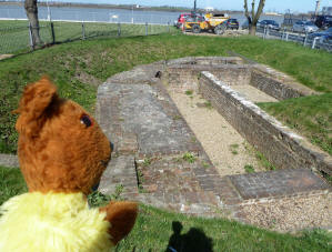 Yellow Teddy looking at remains of Blockhouse