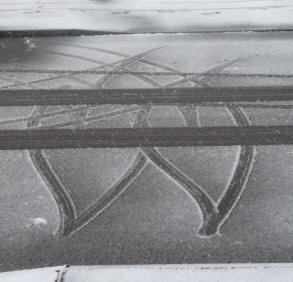 Car tyre marks in snow dust