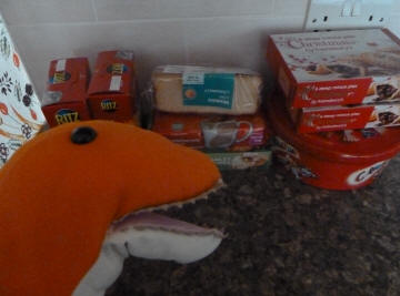 Dino guarding mince pies, cakes and sweets