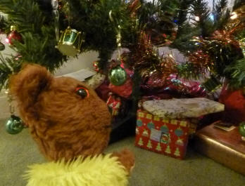 Yellow Teddy with presents under the tree