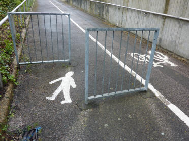 Footpath sign on asphalt