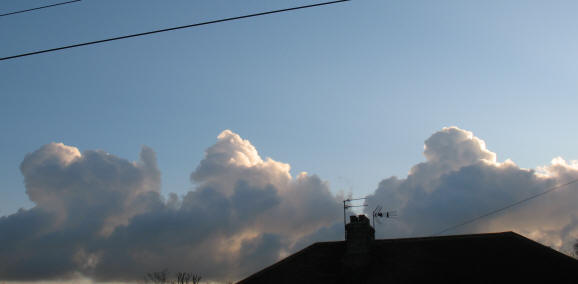 Three piles of cumulus clouds